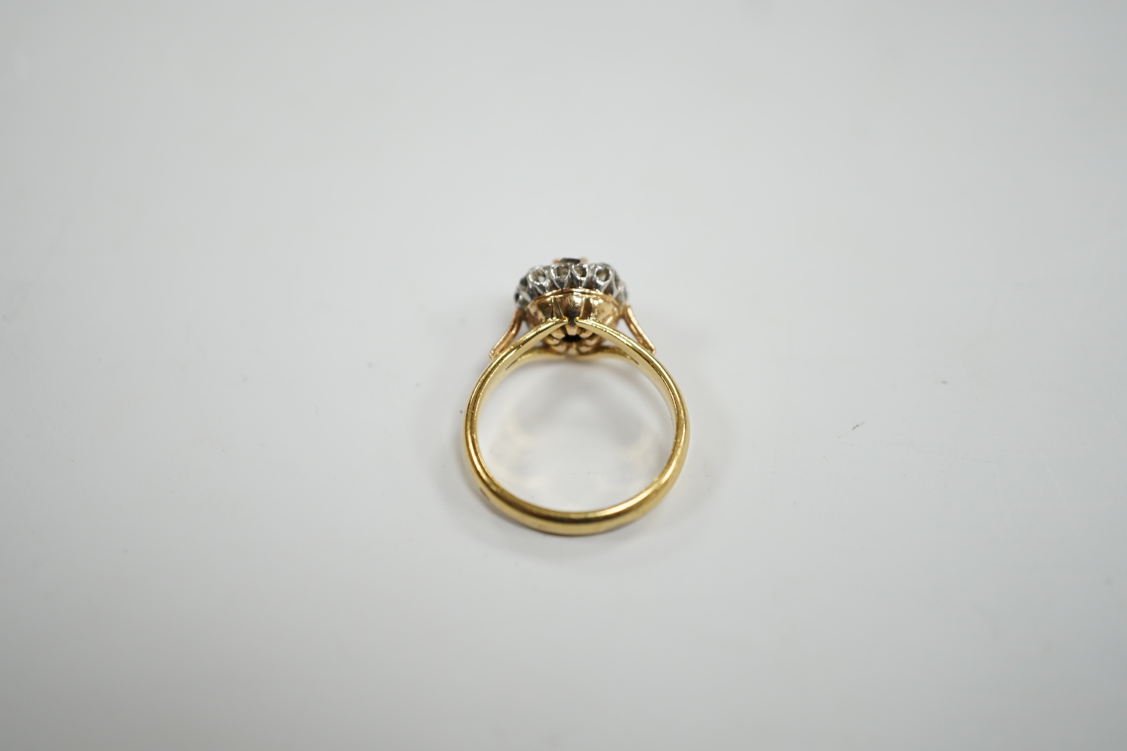 An early 20th century French 18k and nine stone diamond set flower head cluster ring, size G, gross weight 3.4 grams.